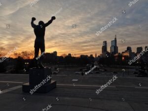 Sun Rises Behind the Rocky Statue